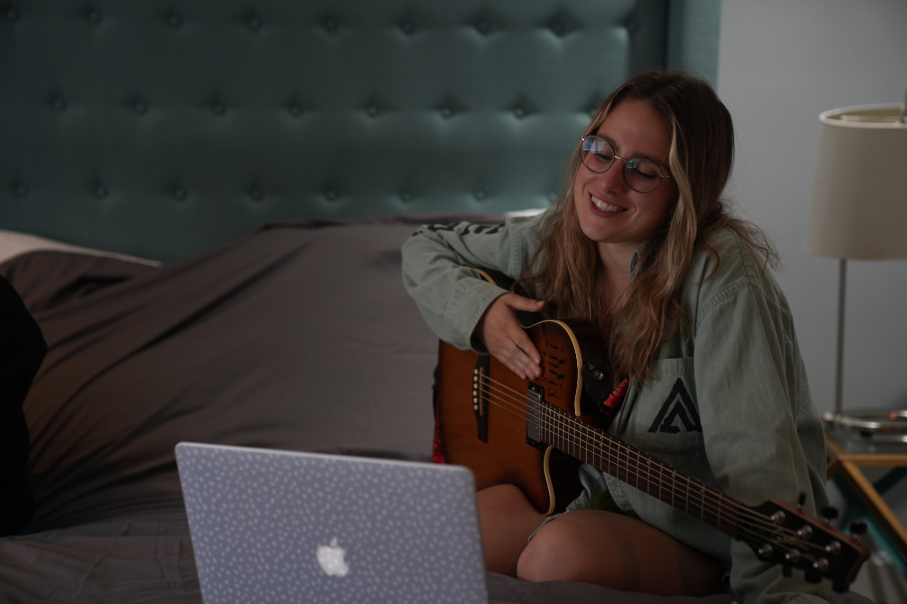 Songwriter laughing with guitar at a SongShare retreat
